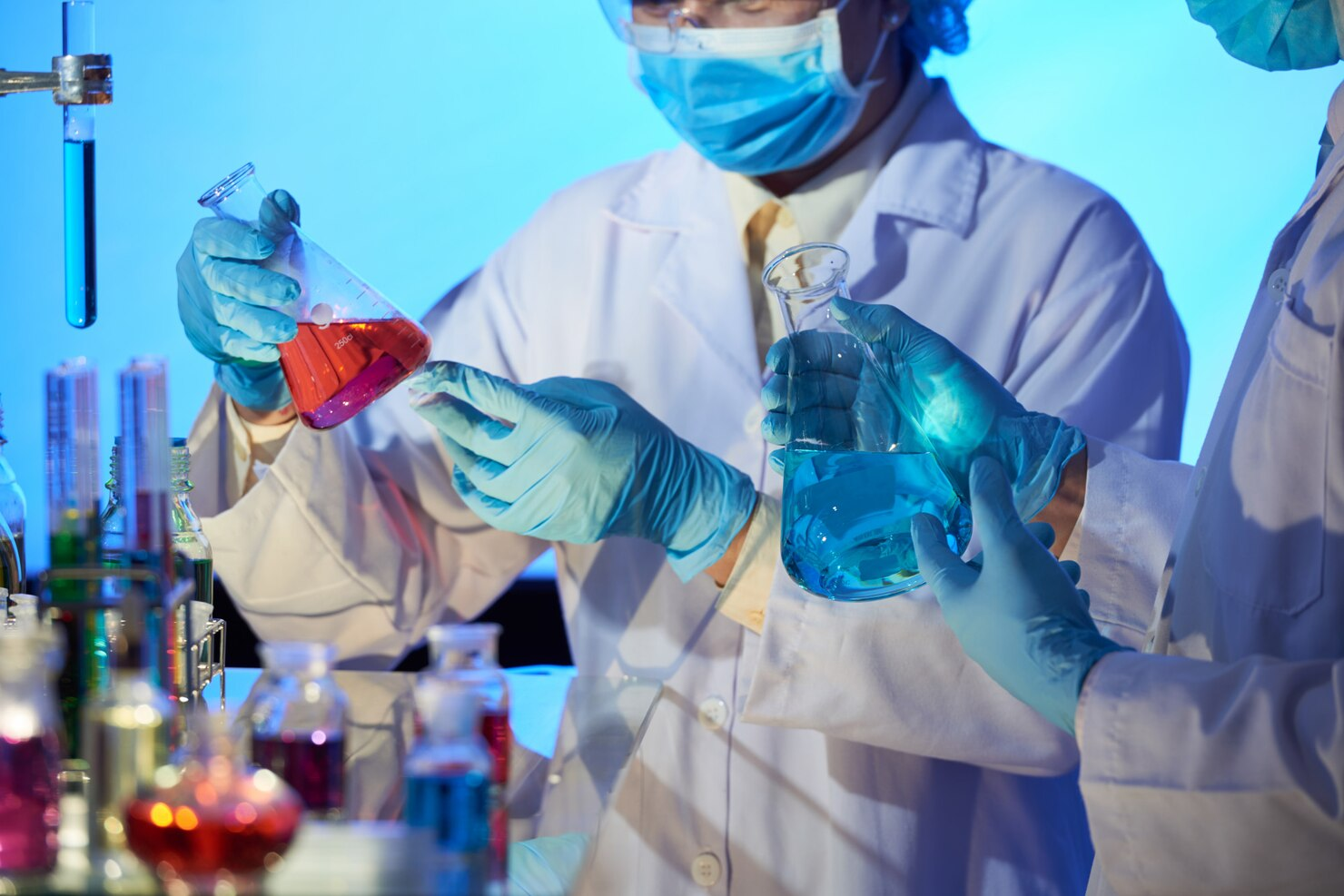 Blue glass laboratory flasks with pipette